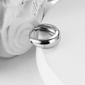 Minimalist wide chunky silver hoop earring with polished finish on a white display stand