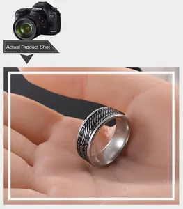 Detail of retro stainless steel ring with fish scale woven texture and polished edges