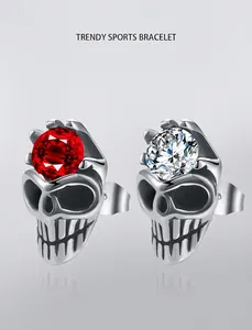 Detail view of skull crown stud earrings with sparkling red and white zirconia stones
