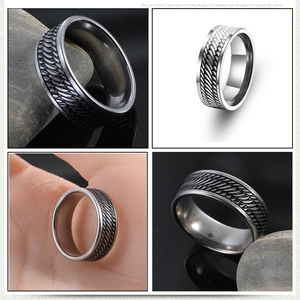 Men's wide stainless steel ring with textured vine pattern and polished edges