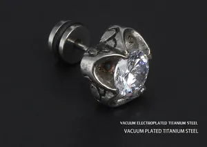 Macro shot of vintage skull claw earring made of titanium steel with zircon stone inlay