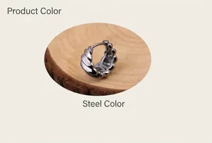 Macro detail of men's steel hoop earring with striped texture on a wooden stand