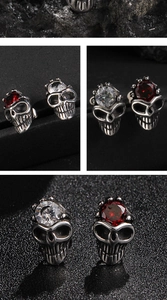 Macro details of gothic skull earrings with red and clear cubic zirconia gemstones