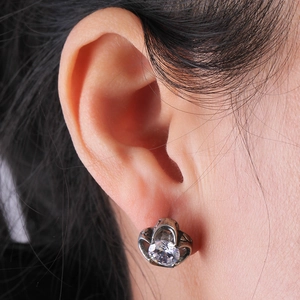 Vintage titanium steel crown stud earrings with round zircon worn by a model