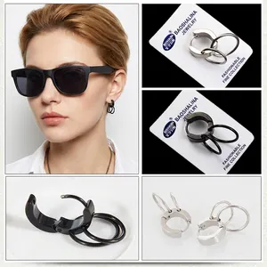 Detail shot of punk style double ring hoop earrings in matte black and silver steel