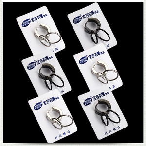 Detailed close-up of punk style titanium steel double hoop earrings in silver and black colors