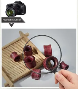 Macro detail of polished violet wood hollow ear gauges showing natural dark red wood grain