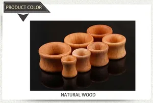Macro shot of natural rosewood hollow ear gauges set in various sizes on black background