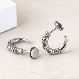 Detail of silver stainless steel dragon claw earrings with bamboo texture and screw back