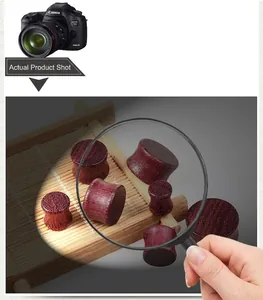 Macro detail of solid purpleheart wood ear plugs with natural grain on bamboo mat
