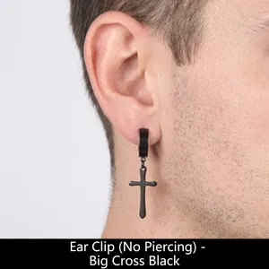 Macro shot of black stainless steel cross clip-on earring worn on an ear for men