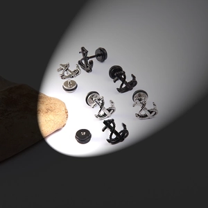 Detailed macro of stainless steel anchor stud earrings in silver and matte black finish