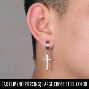 Detail showing a silver stainless steel cross drop earring on non-pierced clip-on ear