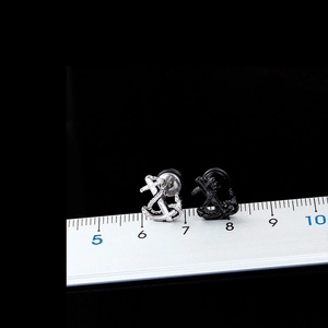 Detailed scale measurement showing 10mm anchor stud earrings in silver and matte black