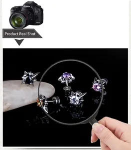 Macro shot of black punk stud earrings set with colorful zircon stones in five shades
