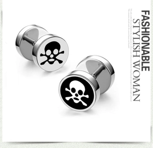 Close-up of barbell skull earrings with polished stainless steel finish and punk design
