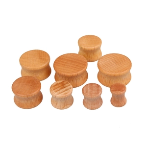 Natural wood heart-shaped ear gauges set with smooth surface and double flared saddle design