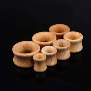 Natural rosewood double flare ear gauges set in various sizes on a black background