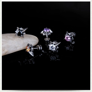 Macro shot of 5-piece punk stud earrings with colorful zircons and metallic spikes