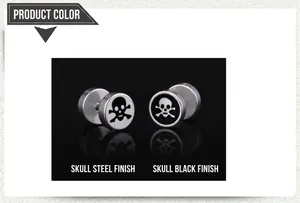 Detailed close-up of punk style skull stud earrings in steel and black finishes