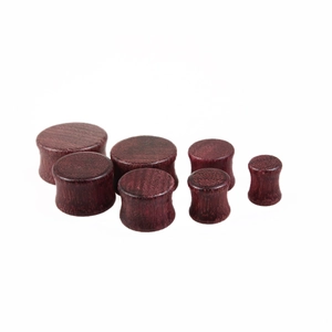 Set of 7 solid purpleheart wood ear plugs with natural grain finish in various sizes