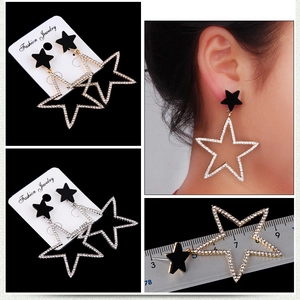 Detail view of large crystal star earrings in gold and silver with size measurements