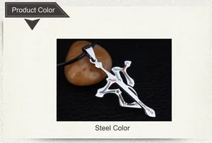 Macro detail of steel Sagittarius pendant with bow, cross design and shell inlay