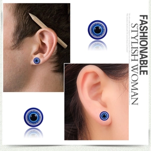 Detailed view of blue evil eye magnetic earrings with sparkling glitter on male and female models