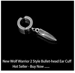 Detailed close-up of bullet-shaped clip-on earring with spiral textures in silver finish