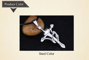 Macro shot of silver Taurus pendant featuring sword and bow design with small crystals
