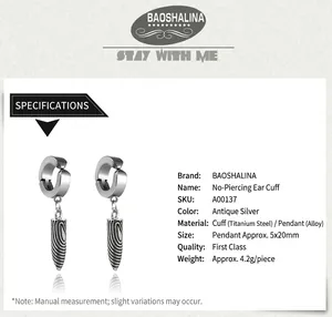 Macro view of silver bullet ear clips made of titanium steel with vintage texture details
