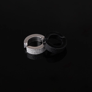 Unisex matte titanium steel clip-on earrings in black and silver on reflective surface