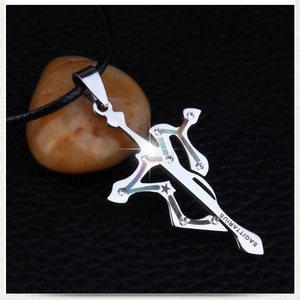 Close-up of Sagittarius cross pendant with sparkling rhinestones and silver finish