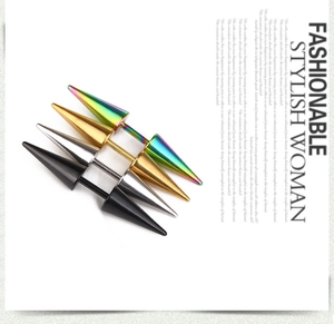 Macro shot of punk style stainless steel double-sided spike earrings in four metallic colors