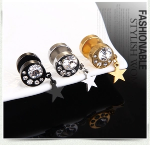 Detailed view of titanium steel star stud earrings in black, silver and gold tones