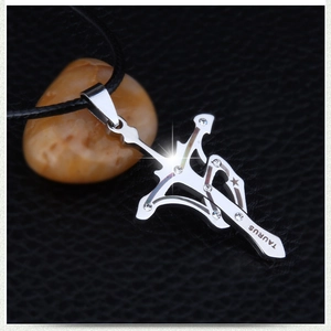 Detailed macro shot of Taurus zodiac pendant with cross and sword elements in 316L steel