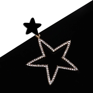 Exaggerated gold-plated star earrings with black studs and pavé rhinestones