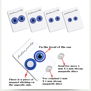 Detail of 5mm magnetic stud earrings with blue evil eye design and spare magnets