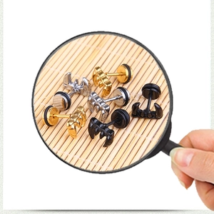 Macro shot of punk claw shaped earrings in gold silver and black stainless steel colors