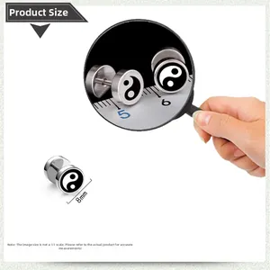 Macro view of 8mm stainless steel barbell earring with black and white Yin Yang design