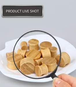 Macro shot of natural bamboo ear gauges in various sizes with fine wood grain texture
