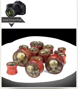Detailed collection of vintage wood ear plugs with alien bronze alloy inlay