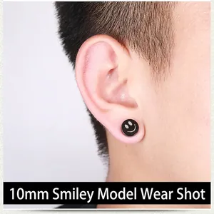 Close-up of 10mm black magnetic smile face stud earring made of polished steel on ear