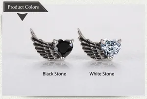 Detailed close-up of retro wing earrings with black and white heart-shaped zircon stones