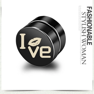 Close-up of black magnetic stud earring with I Love print and red lips on white background