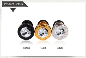 Close-up of retro stainless steel stud earrings with crystal and Greek key pattern