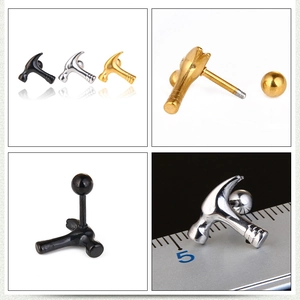 Macro detail of hammer-shaped steel earrings in black, silver and gold with screw backs