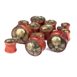 Retro mahogany ear plugs with bronze alien inlay shown in various sizes on white background