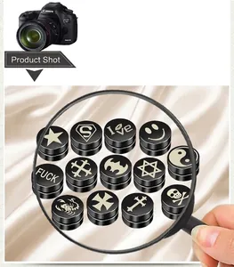 Close-up of 14 pairs of black magnetic punk earrings with assorted streetwear symbols