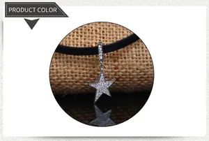 Close-up of a classic silver star pendant with rhinestones on a black choker cord